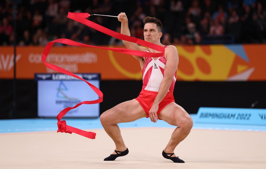 A person performs a silly version of a gymnastic floor routine.