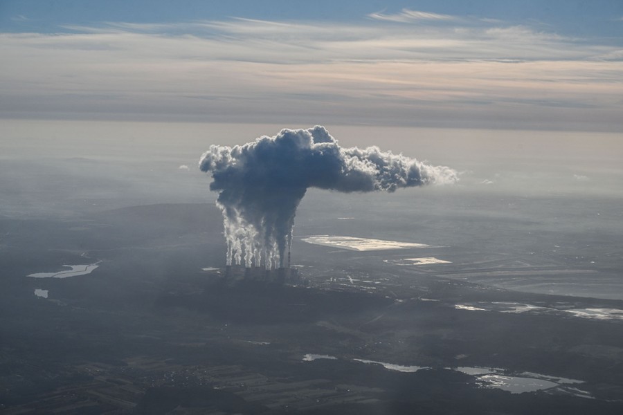 White plumes rise from a power station, in an image captured from the sky.