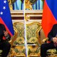 A photo of Nicolás Maduro and Vladimir Putin, torn in the middle