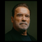Photo of Arnold Schwarzenegger in dark shirt on green background