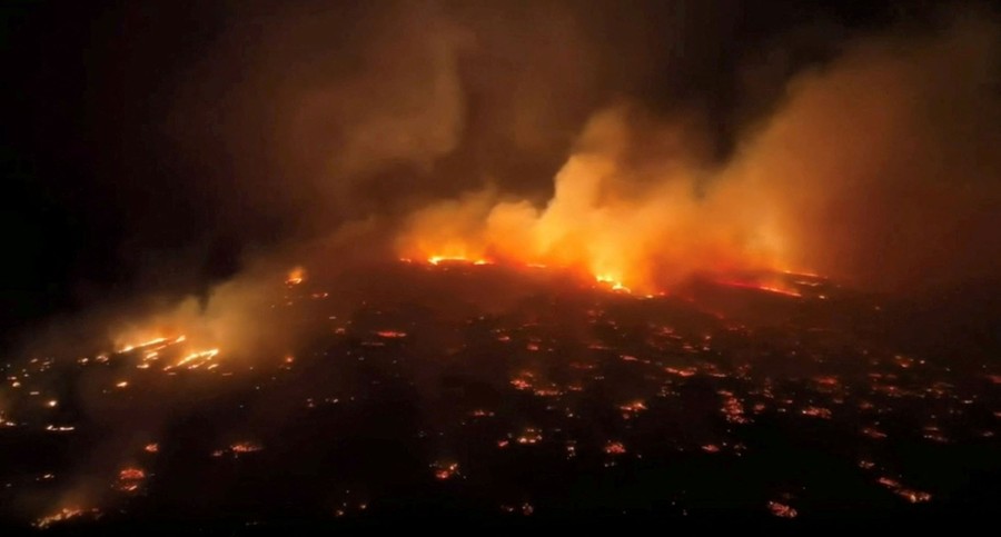 An aerial view of a wildfire, seen at night