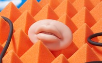 An illustration of lips against an orange background.