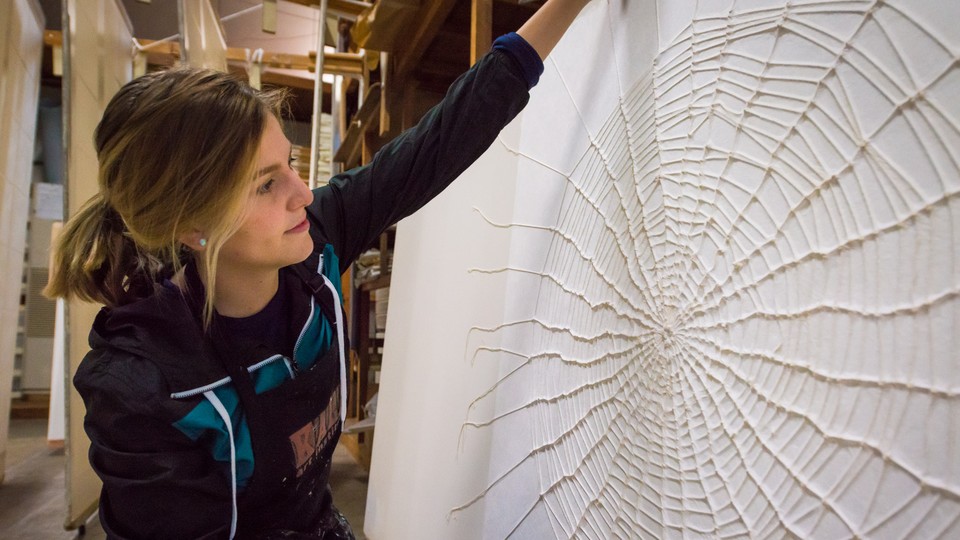 Artist Richelle Gribble with her cotton spider web on kozo washi paper, created during her artist-in-residency in Japan