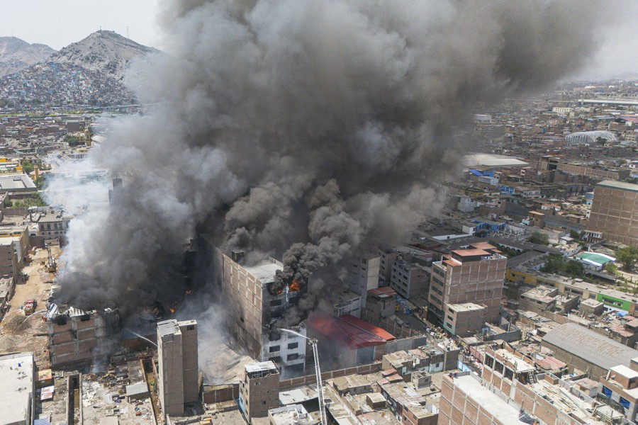 An aerial view of smoke billowing from a city building