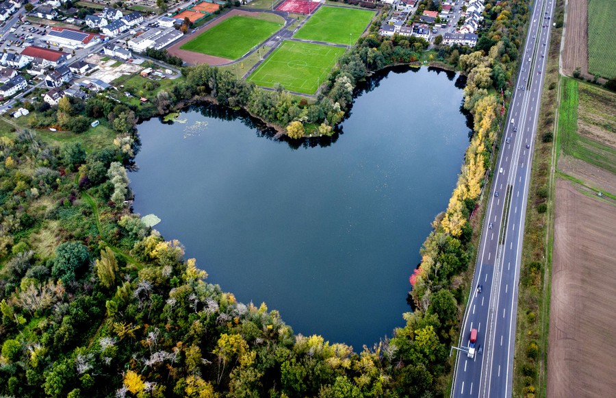An aerial view of a lake in the shape of a heart