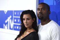 Kim Kardashian and Kanye West pose for a photo