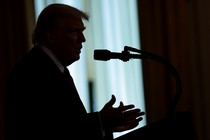 Donald Trump speaking into a microphone