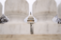 A view of the Capitol building from afar between pillars