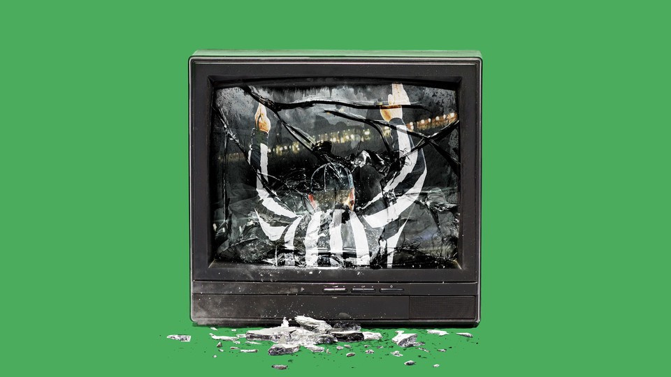 A smashed TV with a referee in its reflection