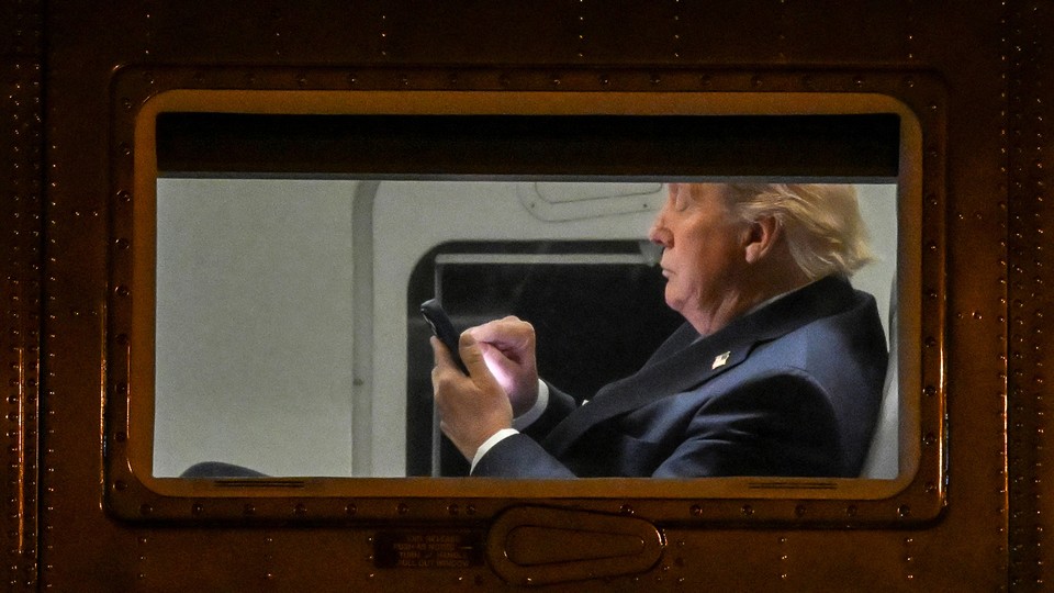 Photograph of Trump typing on a smartphone