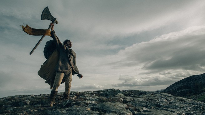 Dev Patel as Gawain holding an axe and screaming