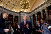 Kevin McCarthy speaks to reporters while standing under a chandelier.