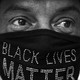 A person wearing a Black Lives Matter face mask.
