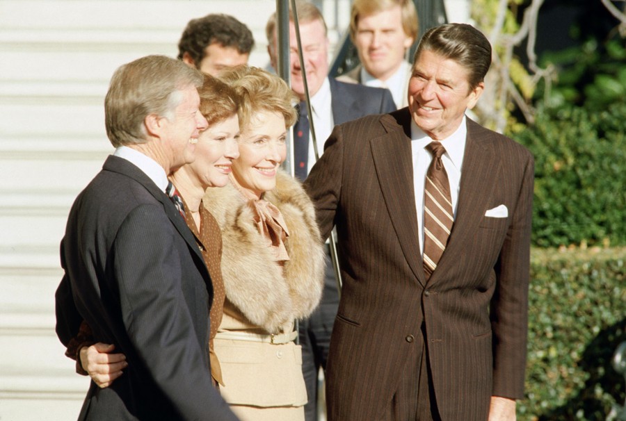 Jimmy Carter and Rosalynn greet Ronald Reagan and his wife, Nancy, at the White House.