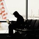 Person working on their laptop at the airport