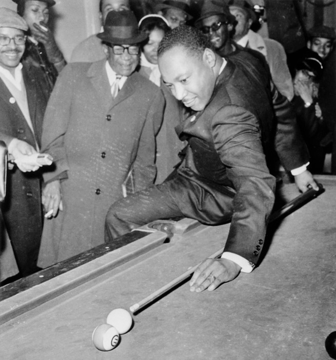 photo of MLK making behind-the-back pool shot in front of crowd