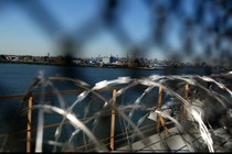 A view of Manhattan through barbed wire at a Rikers Island facility