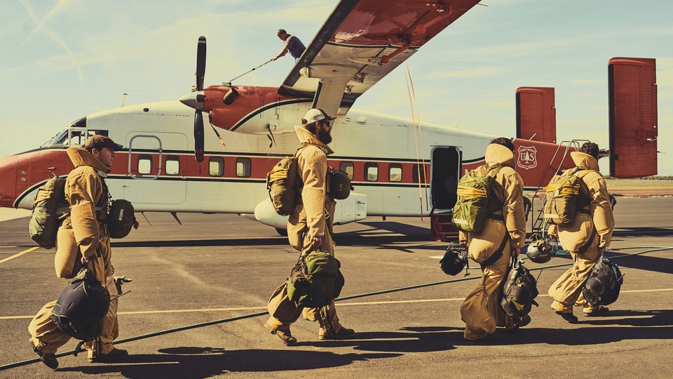 Smoke jumpers in gear boarding a plane