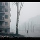 A woman walks past a destroyed building in Mariupol.
