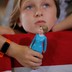 Belle Shefrin, 9, holds a doll of Hillary Clinton while listening to Clinton speak at a campaign rally in Ohio in 2016. 