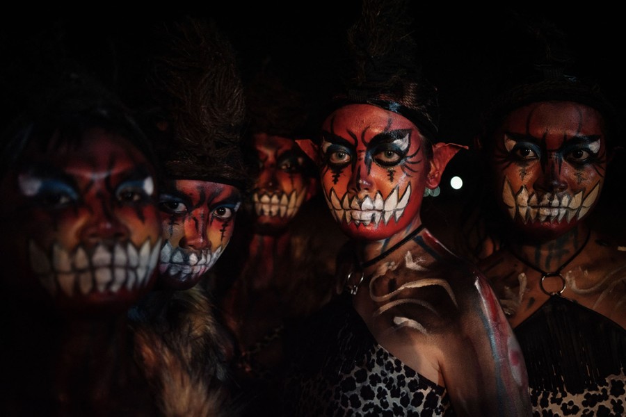 Five young performers pose, wearing frightening makeup.