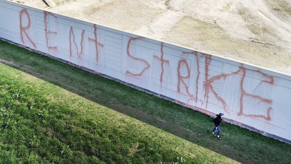A building with "Rent Strike" written across it