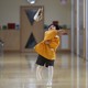 A boy plays in the hallway of a school in Japan