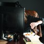 A woman eating in front of a computer