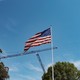 Construction cranes are seen behind a flagpole on the South Lawn of the White House on April 16, 2026.