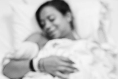 A Black mother holding her newborn