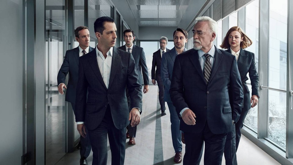 Promotional photo with the cast of Succession walking down a hallway.