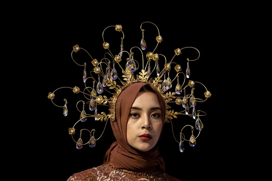 A model displays an ornate headpiece.
