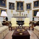Empty Oval Office with portraits hanging on the walls