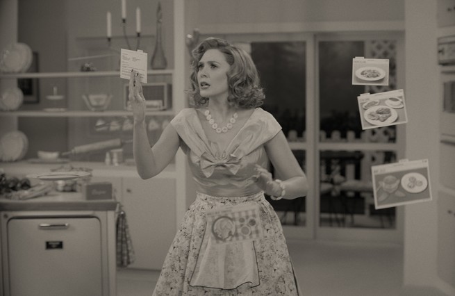Elizabeth Olsen as Wanda holding a recipe in a sitcom-like scene
