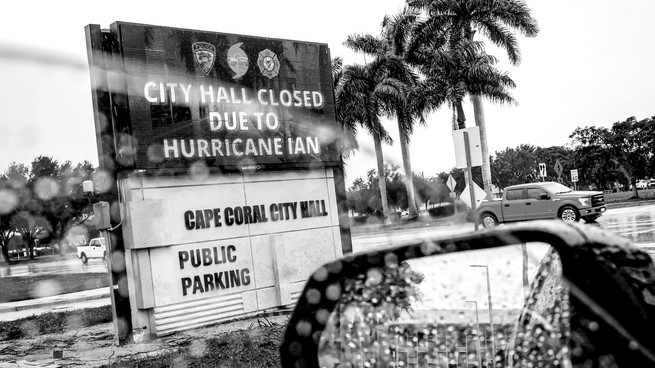 A black-and-white photo of a sign outside a mall in Cape Coral, Florida.