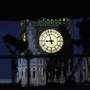 An illuminated clock on the face of Big Ben shines brightly against a dark sky.