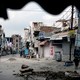 An elderly man walks in an area deserted after communal clashes in Nuh in Haryana state, India, Tuesday, Aug., 1, 2023.