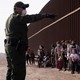 A Border Patrol agent and migrant families