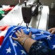 A factory worker sews an American flag