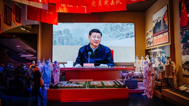 Xi Jinping is seen on a screen in a museum.