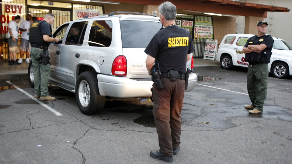 Maricopa County Sheriffs stop a vehicle for a traffic violation during a crime sweep in Phoenix.