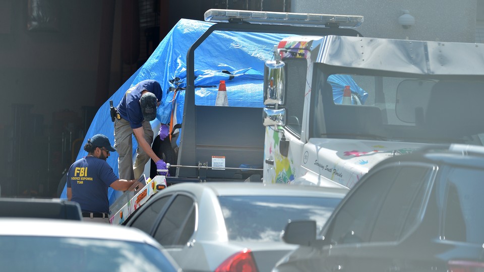 Investigators bring Cesar Sayoc's car to an FBI facility in Miramar, Florida.