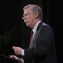 John Bolton speaks at a microphone.