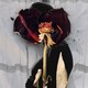 A wilted rose laid over an image of a pregnant woman.