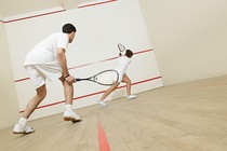 Two people playing squash