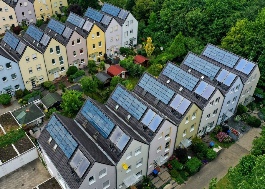 Rows of three-story houses topped with solar panels