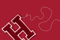 A Harvard "H" patch from which a thread is coming unraveled