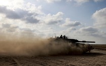 An Israeli army main battle tank moves at a position near the border with the Gaza strip