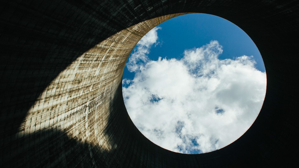 Exhaust from the Watts Bar Nuclear Plant Unit 1 cooling tower drifts over the opening of Unit 2, nearing completion, in Spring City, Tenn., Oct. 8, 2014. With aging coal-burning plants in need of expensive replacements, the Tennessee Valley Authority reasons the reactor is arriving at an opportune moment — even if almost every projection made over the last 44 years has proved wrong.