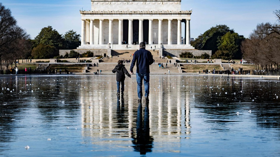 A man and a boy in front of the Lincoln Memorial in Washington, D.C., on December 26, 2022